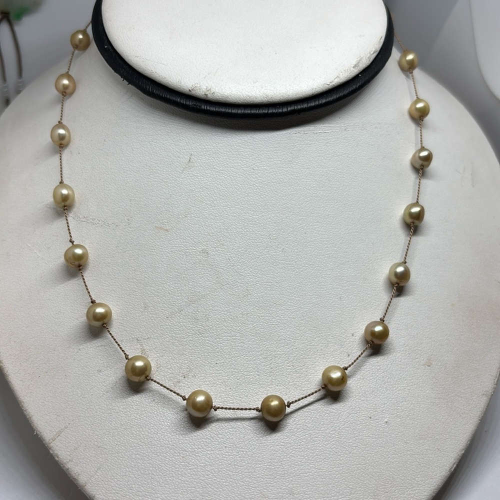 6.5mm  cultured freshwater pearl tin cup necklace. On Griffin cord silver clasp